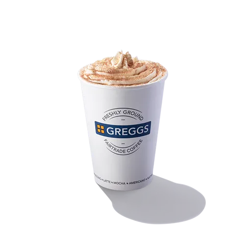 Greggs Menu And Updated Prices In UK 2025 28 Greggs Regular Vanilla Latte served in a takeaway cup, topped with chocolate powder, with steam rising from the creamy milk foam.