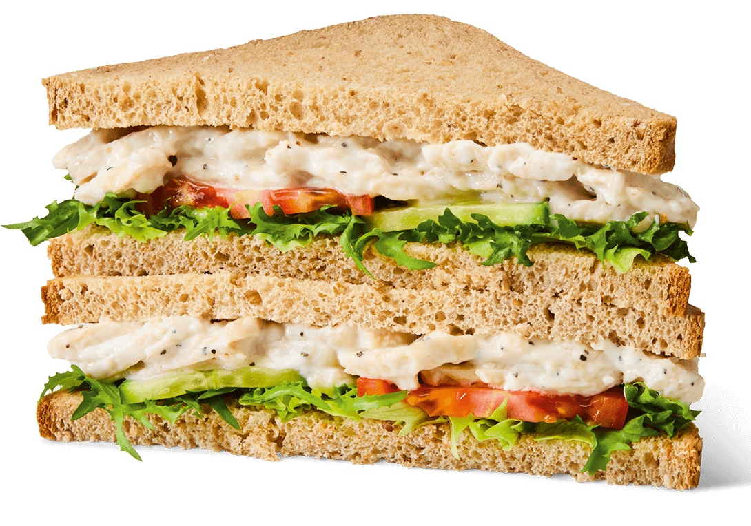 Greggs Roast Chicken Salad Sandwich with tender roast chicken breast, crisp lettuce, tomato slices, and mayonnaise in soft wholemeal bread