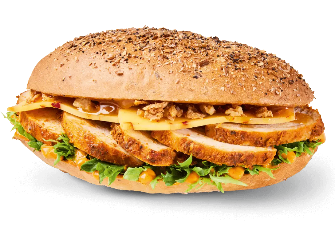 Greggs Menu And Updated Prices In UK 2025 166 Greggs Sweet & Spicy Chicken Oval Bite filled with grilled chicken, pineapple chilli sauce, cheddar chilli cheese, and crispy onions in a seeded oval roll