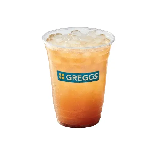 Greggs Menu And Updated Prices In UK 2025 58 A clear cup of Greggs peach iced tea packed with ice, showing a light golden-peach hue, with condensation on the sides and the Greggs logo visible.